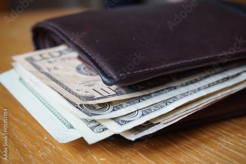  Detail of the American money (USD, US, US dollars), bank notes inserted in the leather wallet