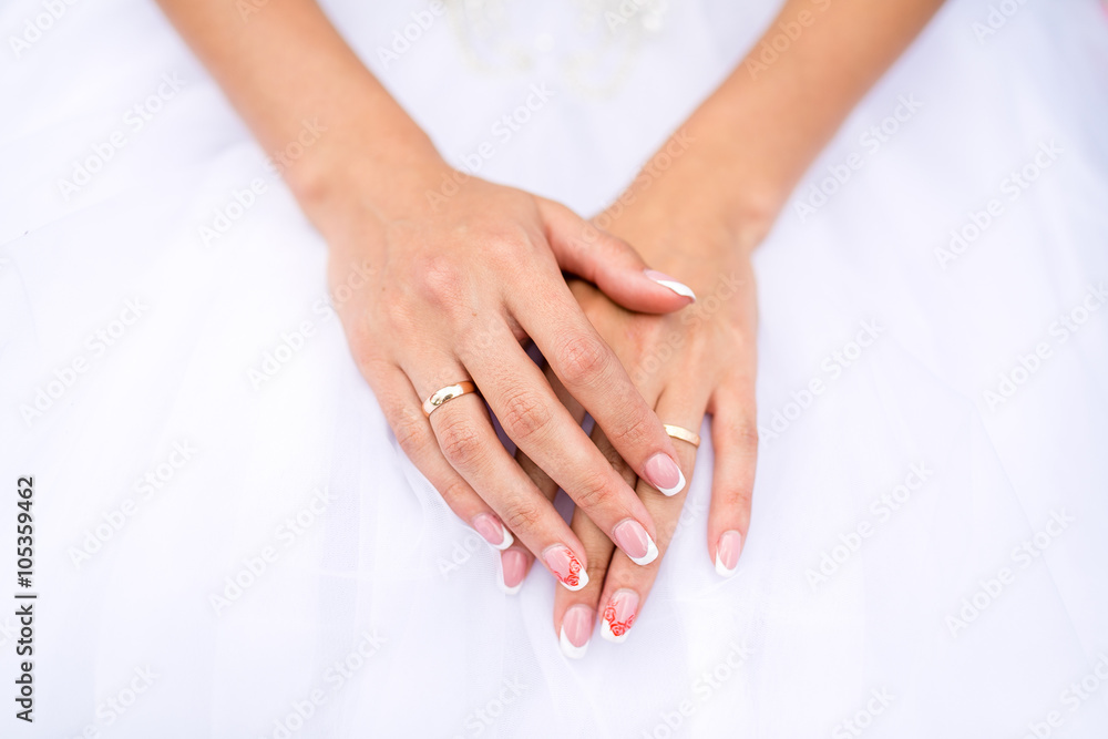 Hands of the bride in white dress