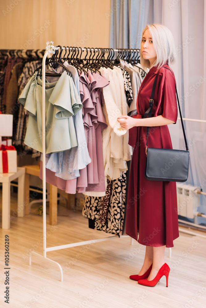 pretty elegant woman shopping in clothes store