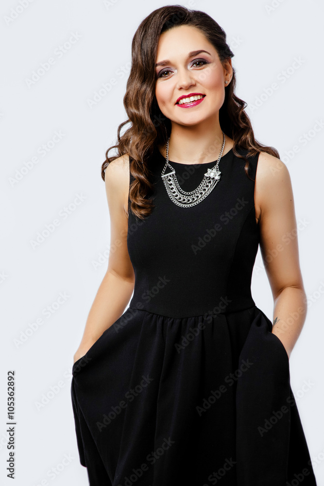 Smiling young woman posing on white background in studio Smiling young woman posing on white background in studio