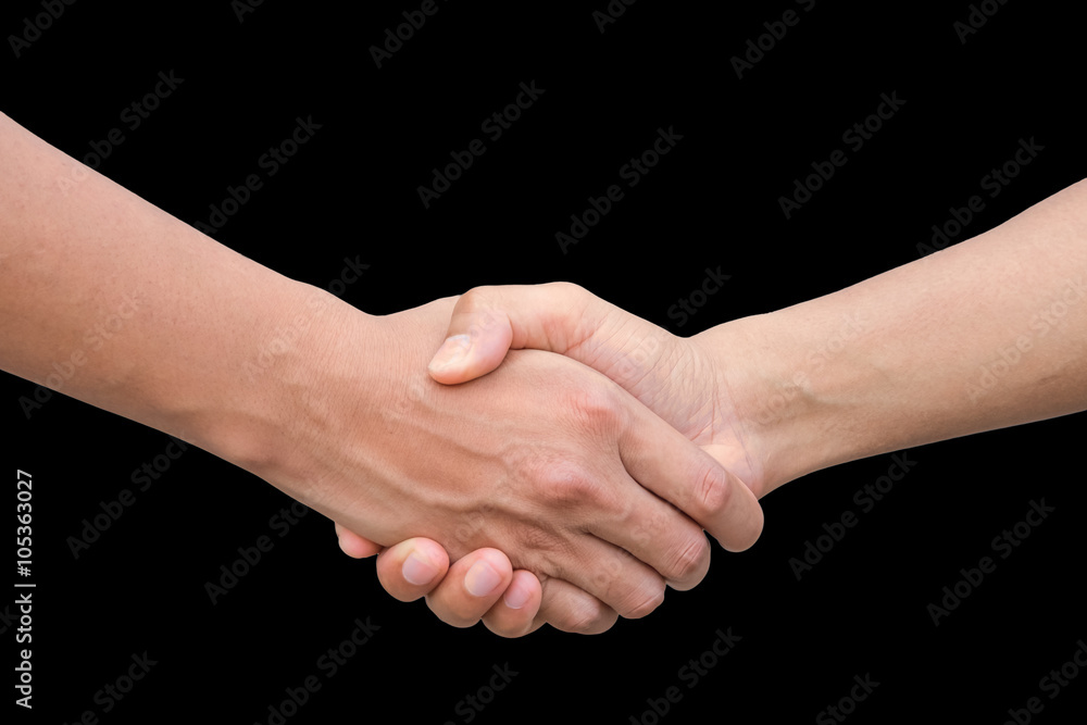 Closeup of two businessmen, lawyers or politicians shaking hands to celebrate a successful agreement with one of them holding the other hand in his pocket. Isolated over black background. Closeup of two businessmen, lawyers or politicians shaking hands to celebrate a successful agreement with one of them holding the other hand in his pocket. Isolated over black background.