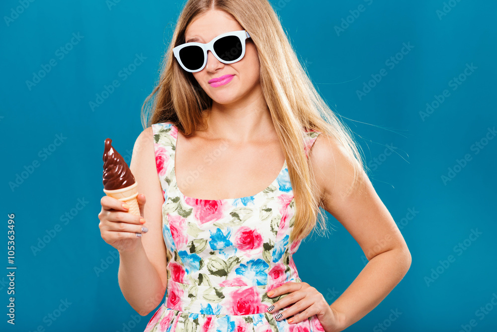 Upset pretty girl holding plastic ice cream in her hand Upset pretty girl holding plastic ice cream in her hand