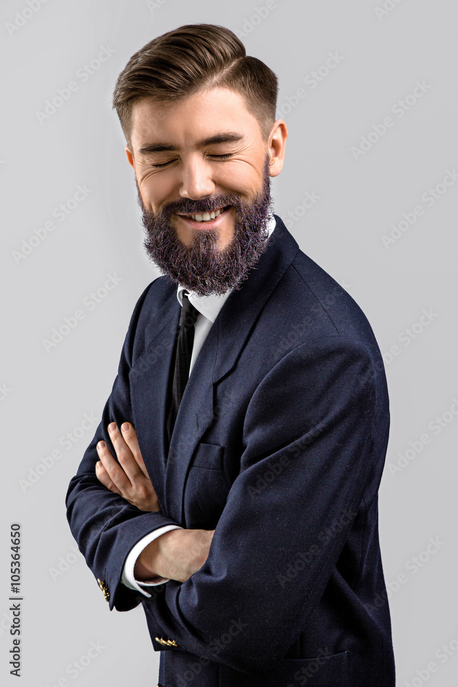 Cheerful man posing with crossed hands and laughing Cheerful man posing with crossed hands and laughing