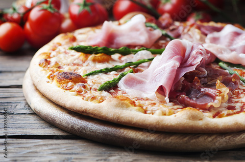 Italian pizza with ham and asparagus