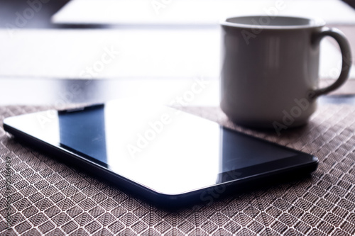 Wallpaper Mural Coffee cup and tablet pc on kitchen table  Torontodigital.ca