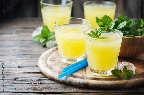 Yellow fresh cocktail with mint and ice