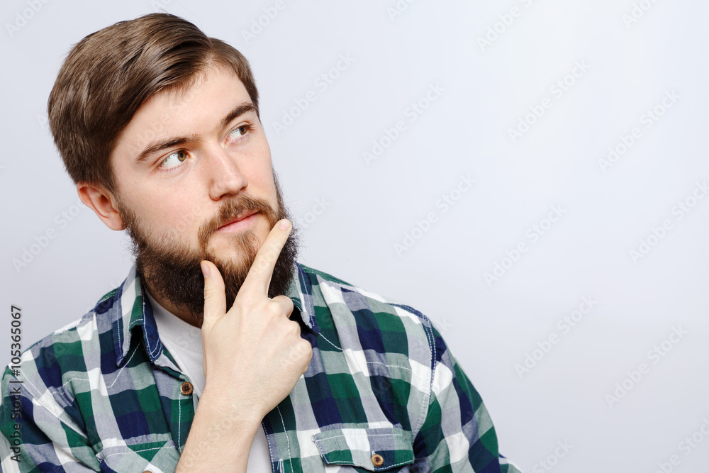 Bearded young man thinking on white background, in studio Bearded young man thinking on white background, in studio