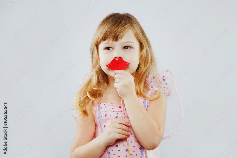 Little fairy posing with paper lips on white background Little fairy posing with paper lips on white background