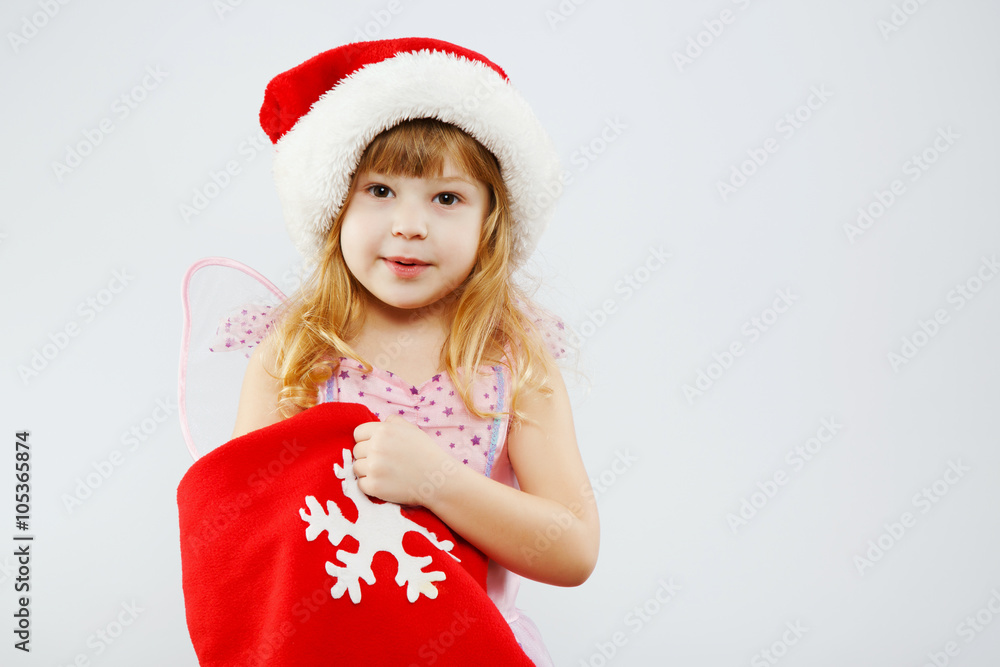 Pretty little blond girl posing with red bag for presents Pretty little blond girl posing with red bag for presents