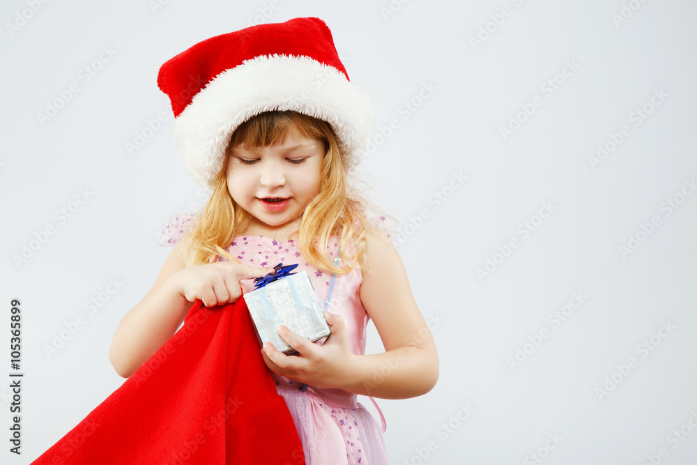 Little girl holding red bag for presents in studio Little girl holding red bag for presents in studio
