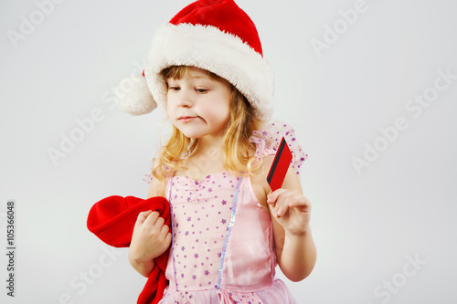 Little serious girl, posing with red bag for presents