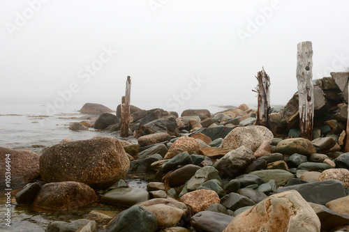 Rocks and Old Wooden Posts at the Bay
