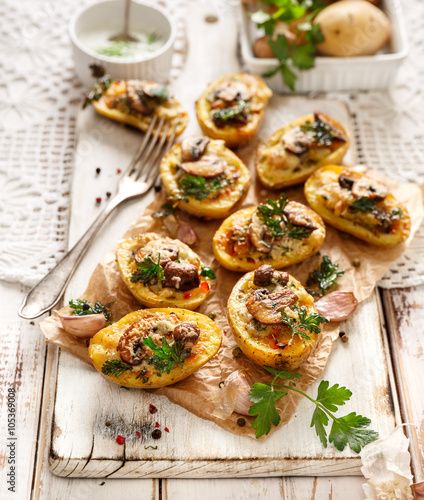Baked Potatoes stuffed with mushrooms, onion, herbs and cheese