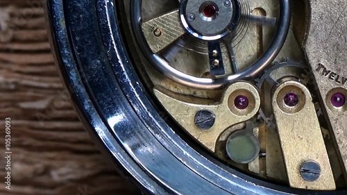 Gear inside ancient watch / Moving gears inside ancient mechanic watch in slow motion photo