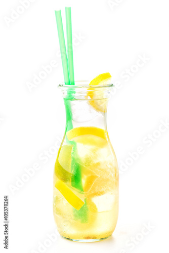 fresh tropical or summer lemonade with lemon, lime and ice in glass, beverage isolated on white background