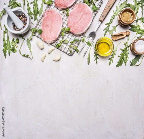 Ingredients for cooking pork with herbs and pepper border ,place for text on wooden rustic background top view