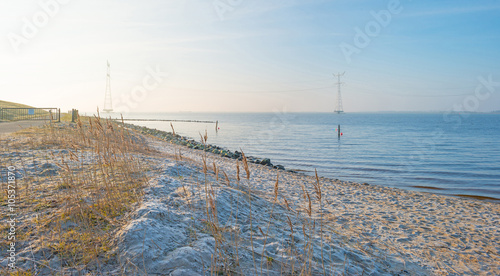 Beach along a lake in winter at sunrise