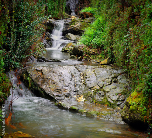 mountain stream waterfall with stones