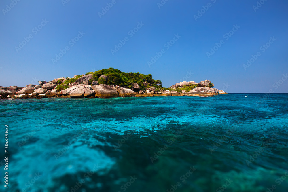 a small beautiful tropical island with clear turquoise water