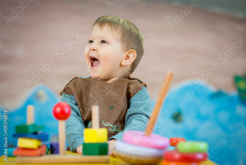 Caucasian boy smiling and playing with toys