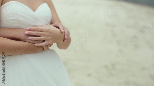 Bride and groom embracing tummy with a future baby. photo