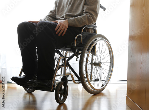 disabled elderly in a wheelchair in the room photo