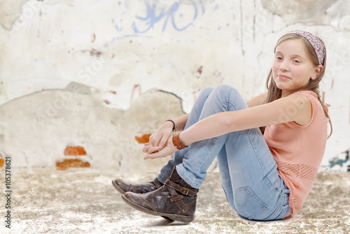 young preteen sitting on the floor