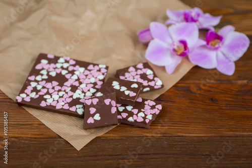 chocolate bar with hearts on a wooden background