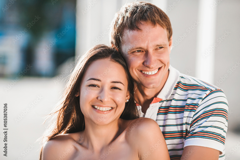 The guy embraces his girlfriend during a walk in the fresh air The guy embraces his girlfriend during a walk in the fresh air