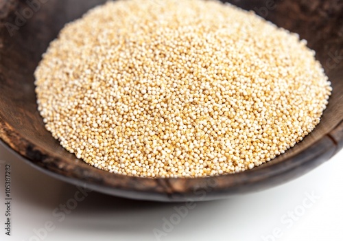 Amaranth puffed in rustic wooden bowl isolated white background