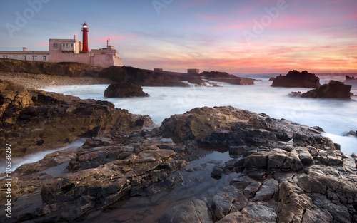 Sunset and a beautiful lighthouse  twilight rocks