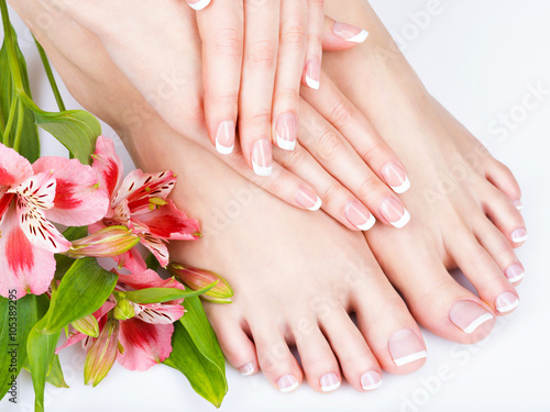 female feet at spa salon on pedicure and manicure procedure