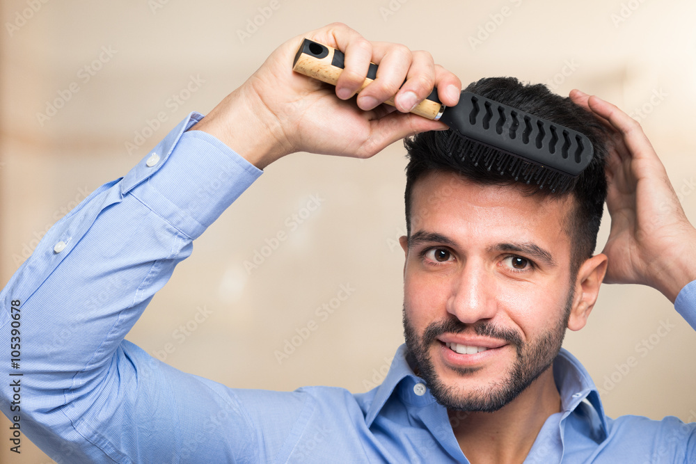 Man brushing his hair Stock Photo | Adobe Stock
