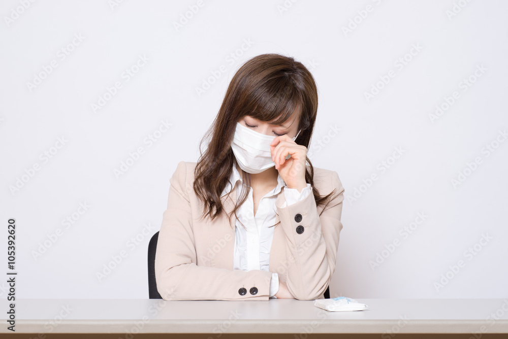 オフィスでマスクをしている女性 オフィスでマスクをしている女性