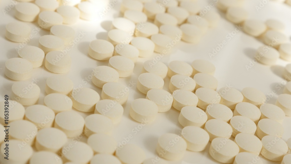 Many round tablets on white reflective surface arranged 4K 2160p UltraHD tilt video - Slow tilting over health care medics on white background 4K 3840X2160 UHD footage Many round tablets on white reflective surface arranged 4K 2160p UltraHD tilt video - Slow tilting over health care medics on white background 4K 3840X2160 UHD footage