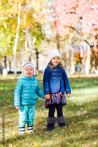 Little girls running in autumn park