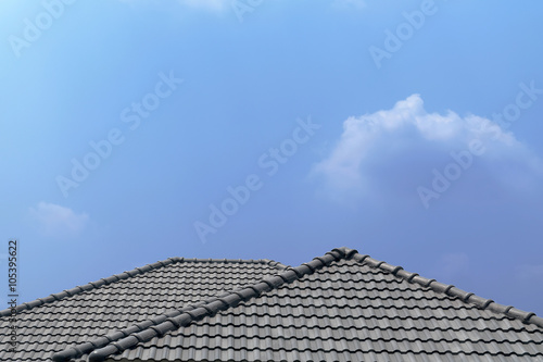 Roof house with tiled roof on blue sky