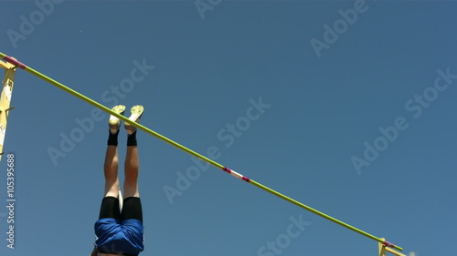 Track and Field athlete doing pole vault, slow motion photo