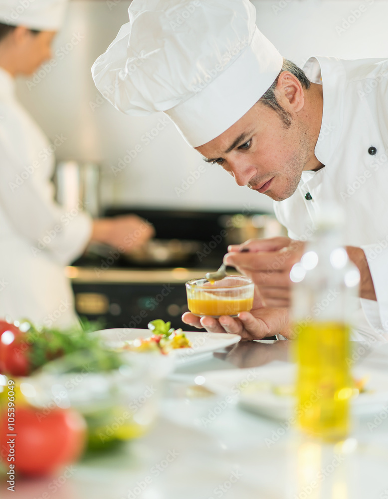 Portrait of a cook chef putting sauce on a plateful Portrait of a cook chef putting sauce on a plateful