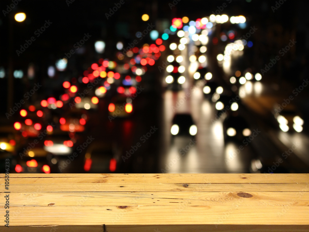 Wood table for product placement, blurred traffic jam