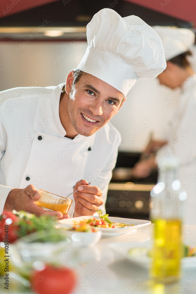 Portrait of a man chef putting sauce on a plateful Portrait of a man chef putting sauce on a plateful