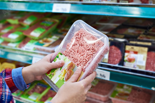 Buyer chooses minced meat in store