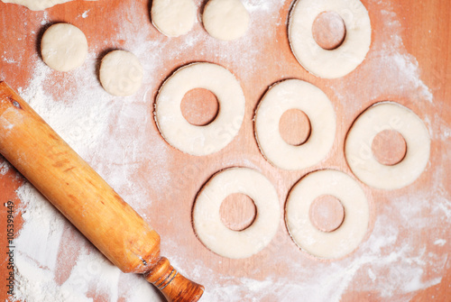 The pastry chef prepares the donuts from dough
