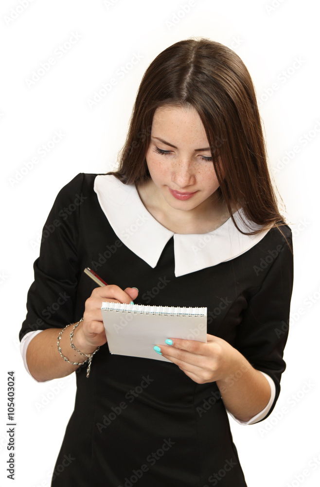 teenager girl with a notebook and the pen in hands