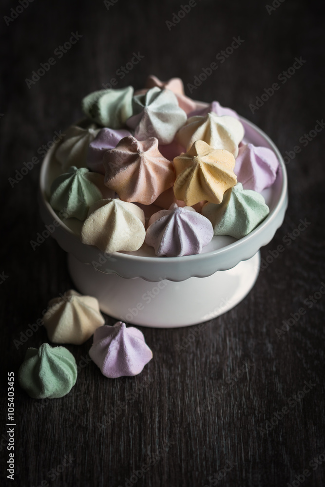 Meringues on white stand with moody feeling Meringues on white stand with moody feeling