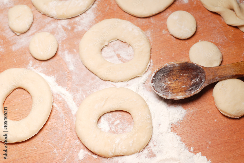 The pastry chef prepares the donuts from dough The pastry chef prepares the donuts from dough