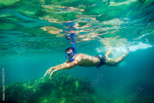 snorkling man swim underwater
