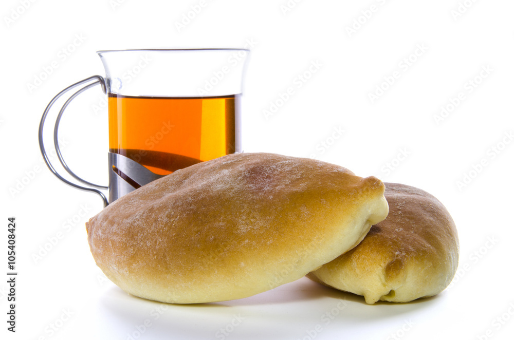 Two patties with a cup of tea on a white background Two patties with a cup of tea on a white background