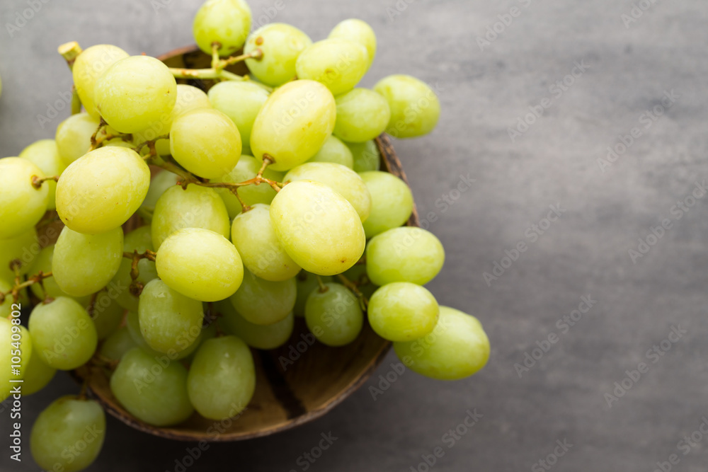 Grape cluster on the grey background.