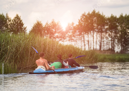Young people are kayaking on a river in beautiful nature © lkoimages